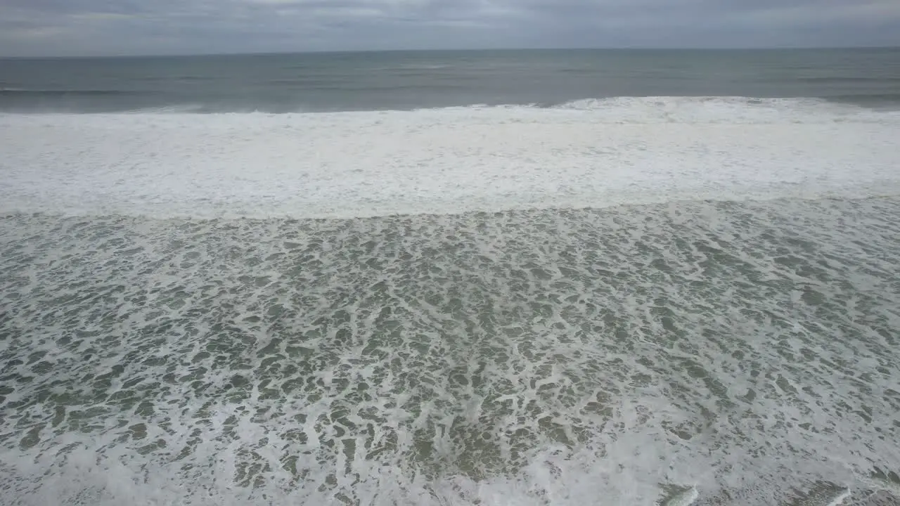 Sea waves on deserted beach in sunny day