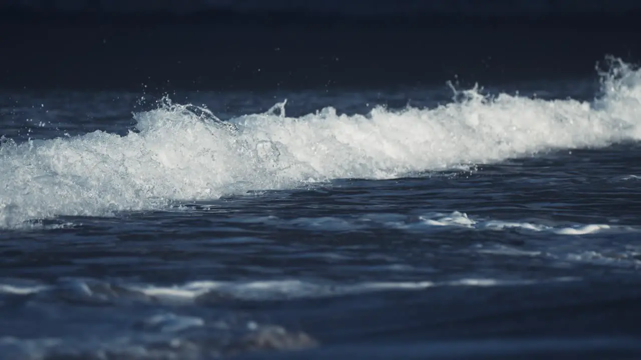 Gentle waves roll on the sandy beach in Ersfjord