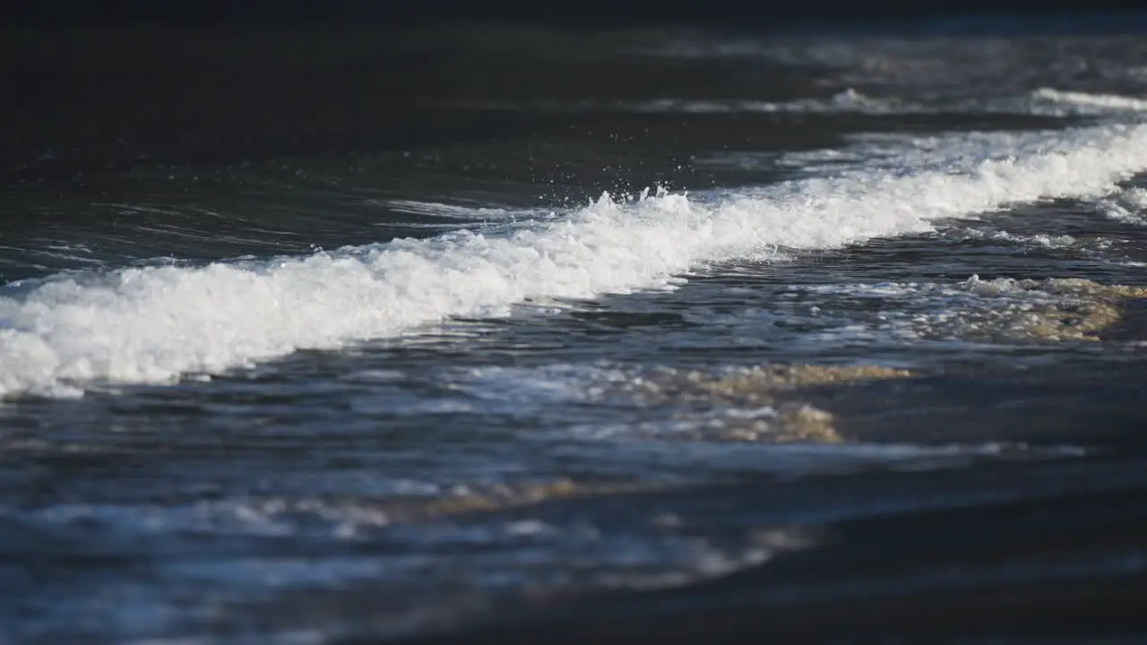 Powerful waves roll on the shallows of the sandy beach in Ersfjord