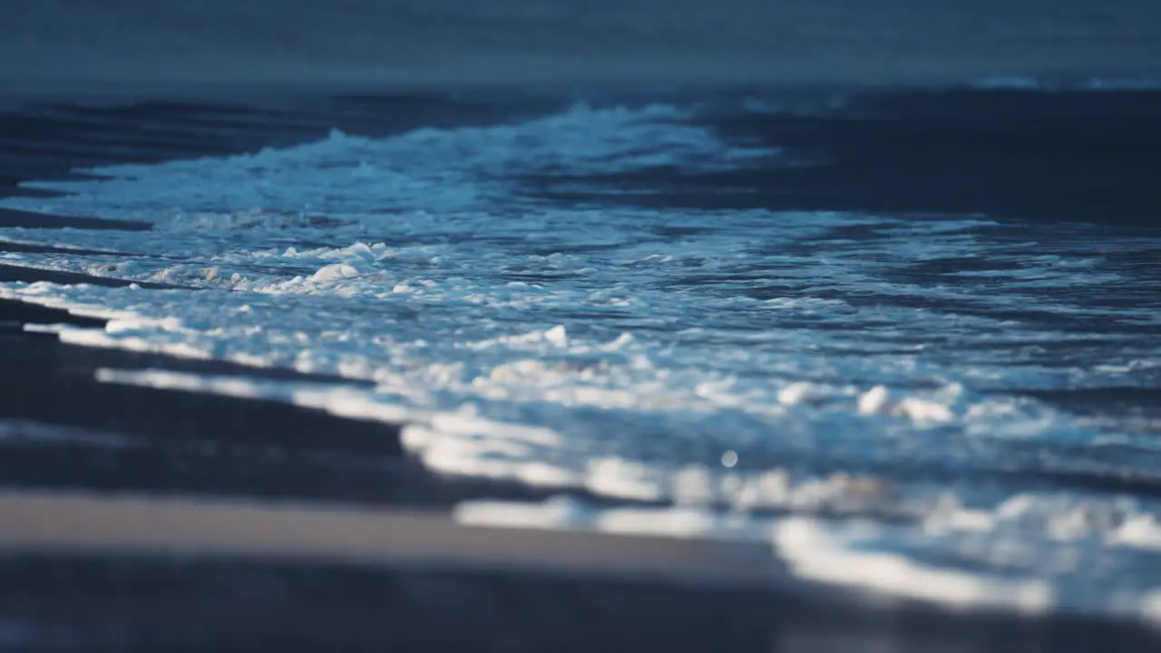 The powerful waves break around the sandy shallows on the Ersfjord beach