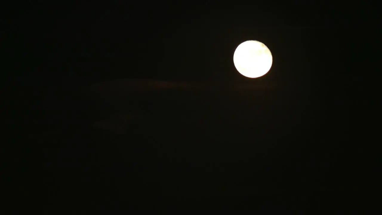 Timelapse of a bright moon moving during the night with no clouds 