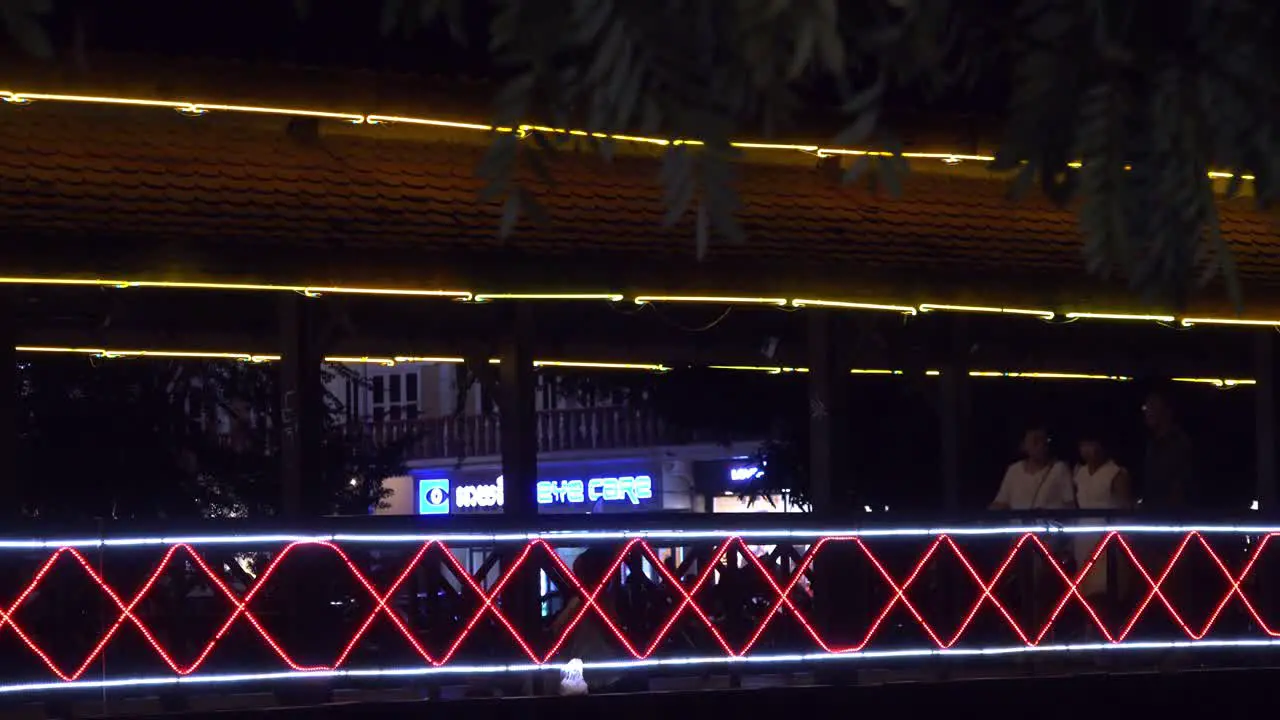 Tourist Walking on a Illuminated Bridge