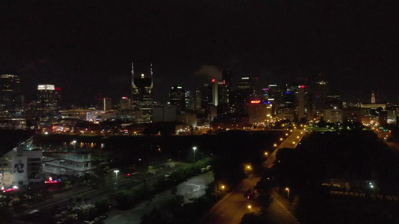 Moving exterior 4k shot aerial of Nashville skyline at night