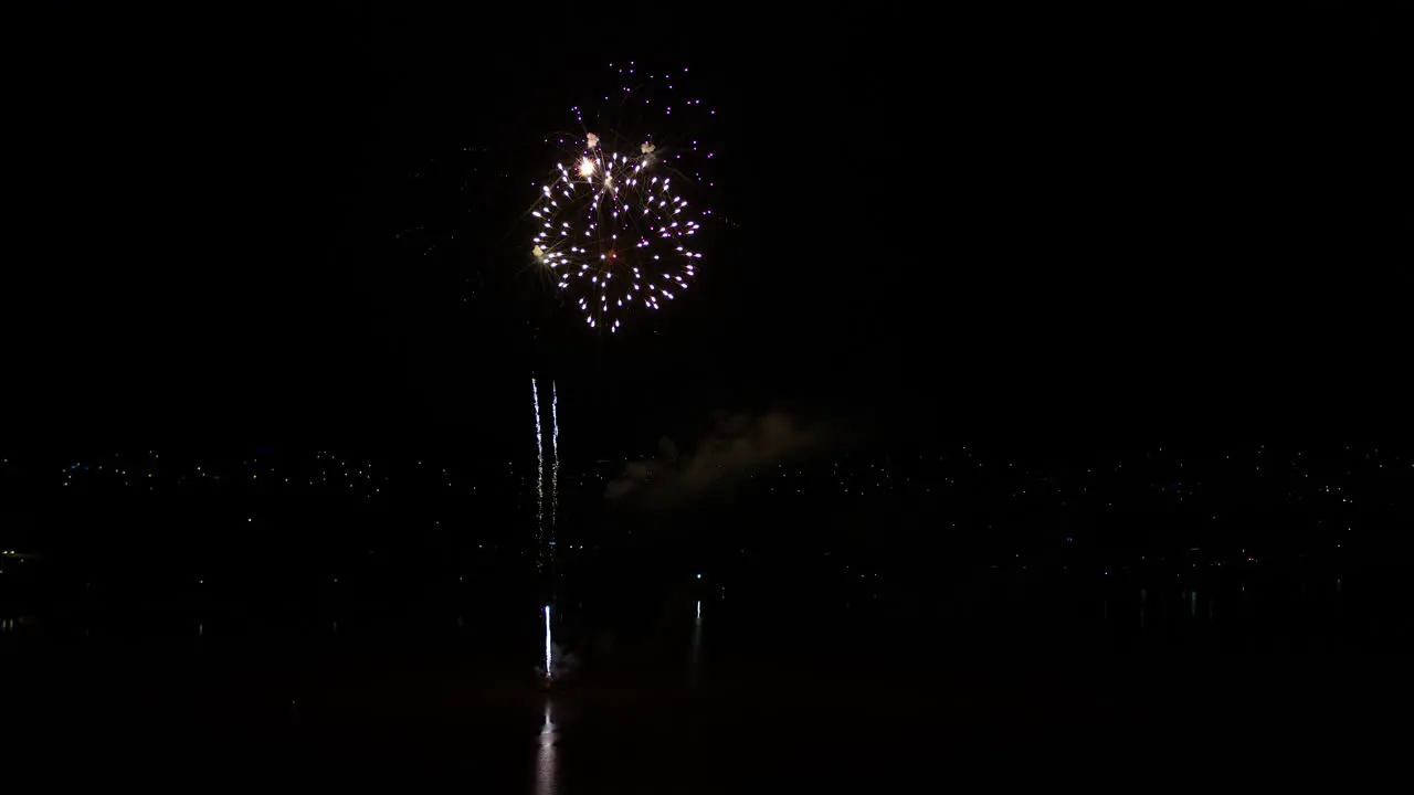 Aerial drone shot of Fireworks display over a large lake in rural Australia