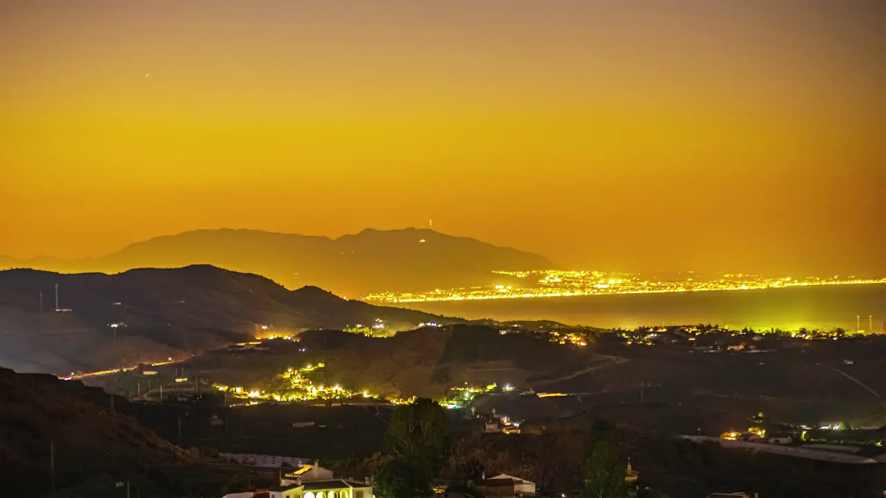 Beautiful coastal city with night lights during sunrise time lapse view