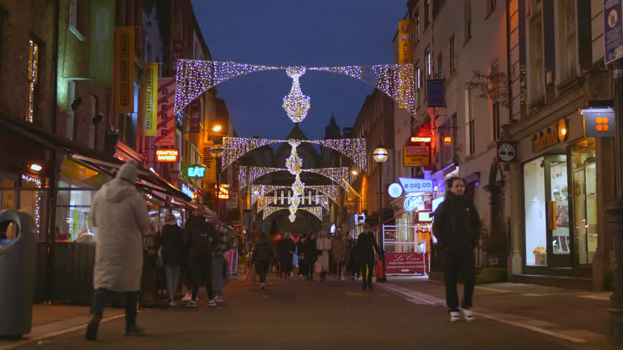 Tourists walking along a decorated street during Christmas in Dublin Ireland