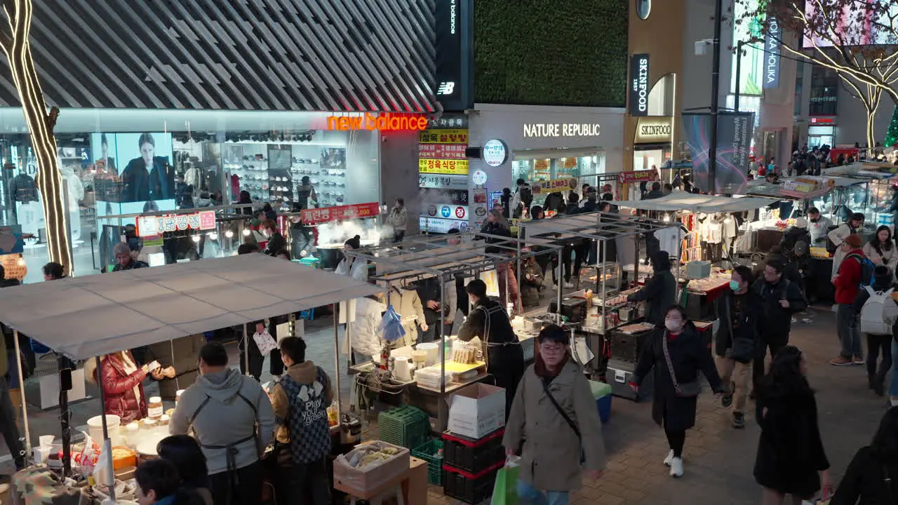 Myeongdong Night Market in Seoul Line of Street Food Stalls Selling Snacks and Grilled Korean Cuisine at Pedestrian Shopping District