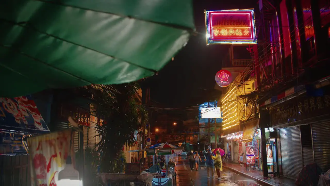 Rainy wet Bangkok Street at Night with Colorful Neon Lights