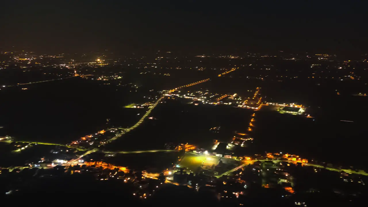 Timelapse of city shot from above at night with moving lights of cars