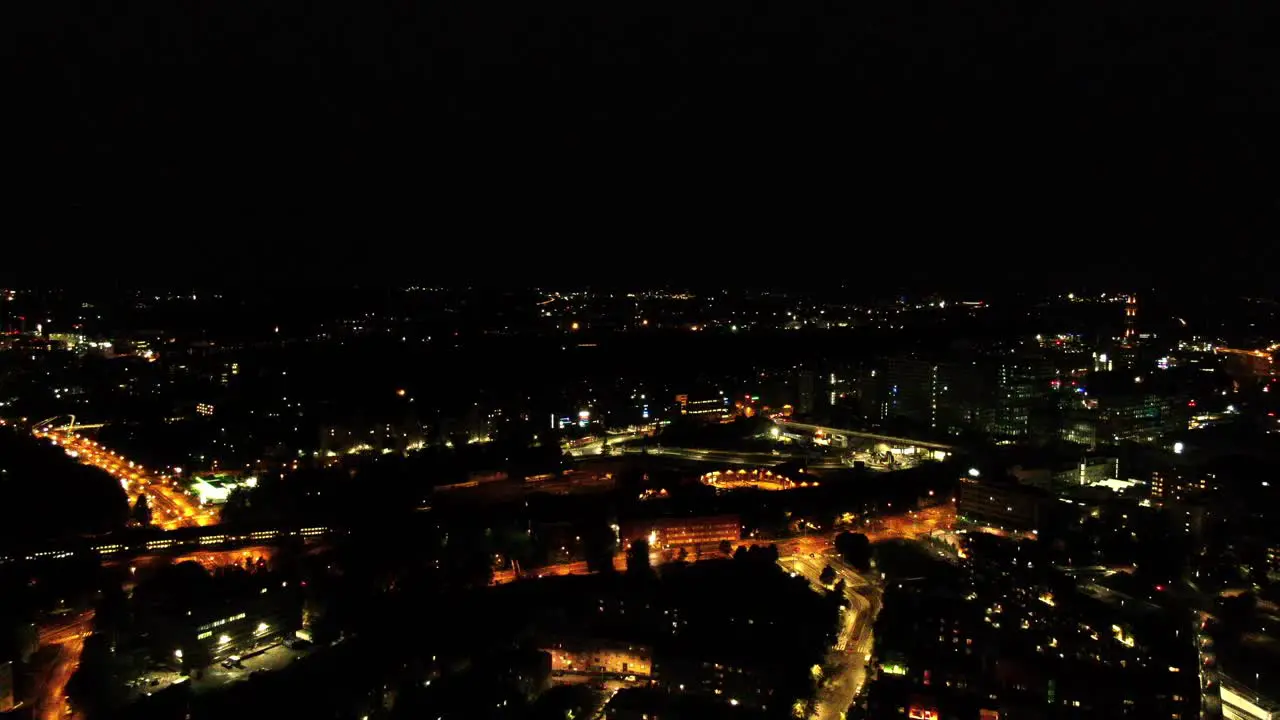 A smooth approaching aerial shot on Helinski Finland as a train passes through the city in the distance