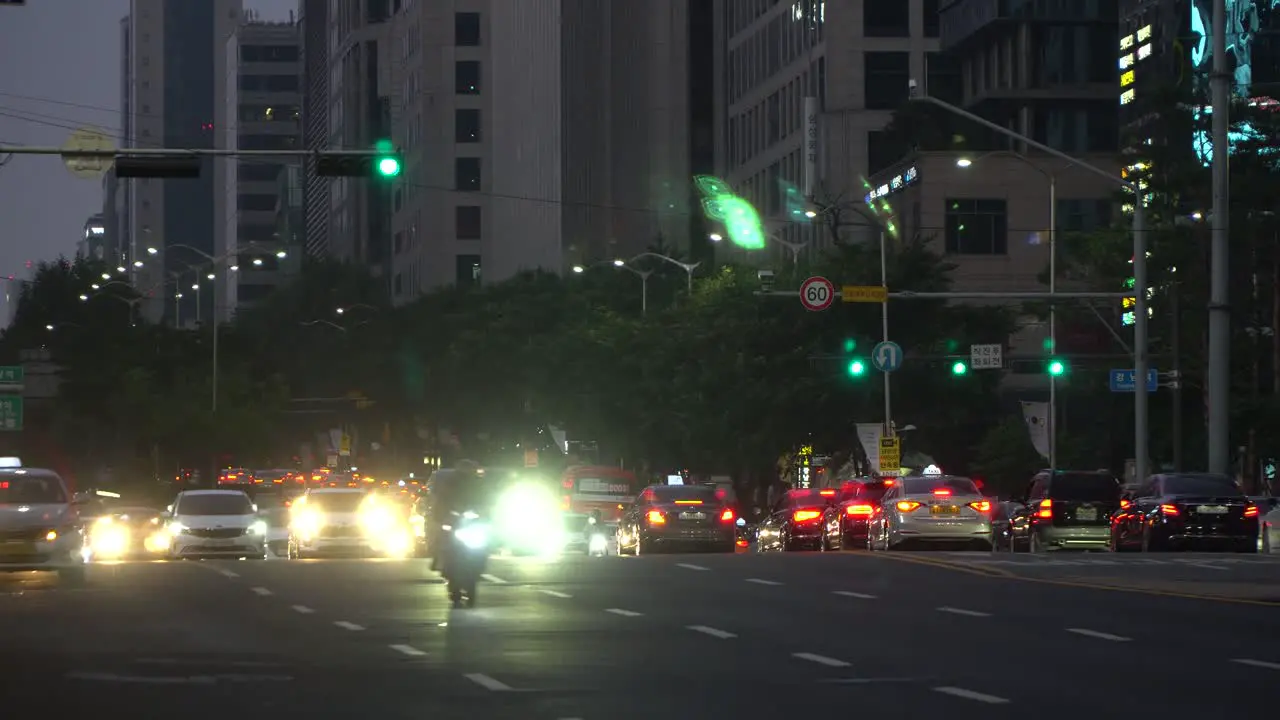 Numerous cars and buses passing by at a multilane crossroads at Gangnam station on green signaling light Seoul South Korea