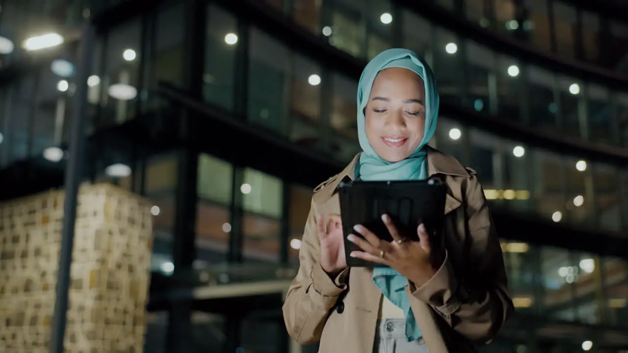 Muslim woman on tablet in night city