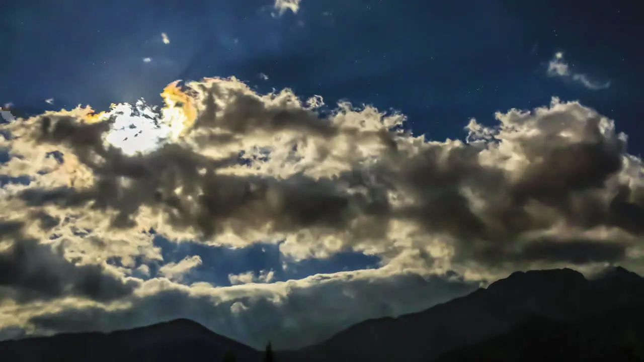 Part 2 of 2 Dramatic Time Lapse sequence of a full moon moving across the sky above a high mountain peak