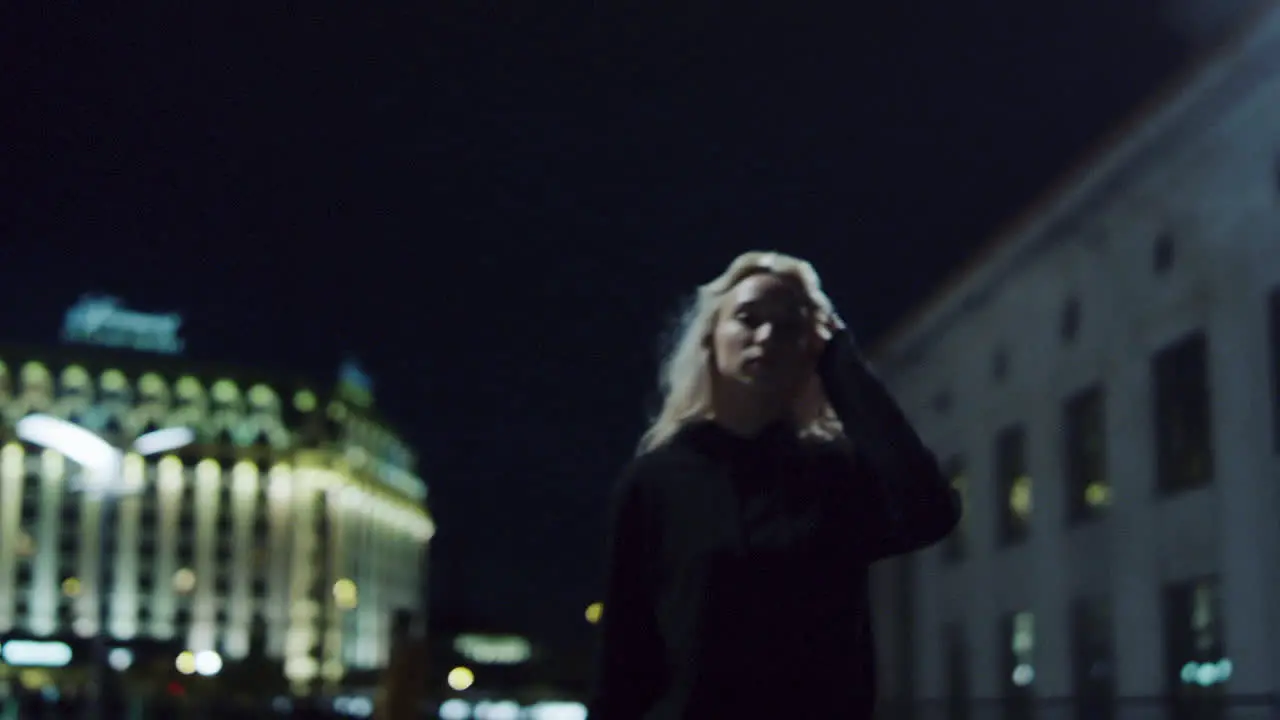 Confident girl walking city at night street lights in urban background