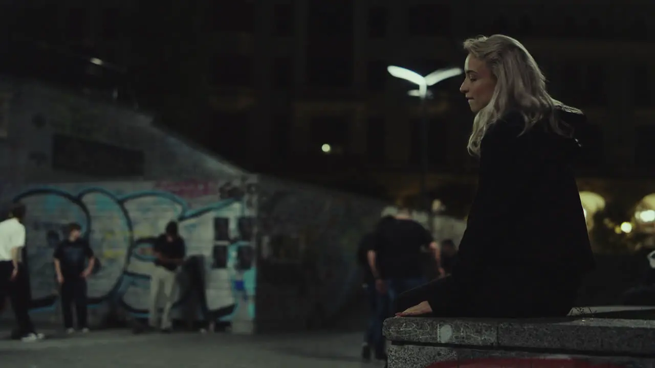 Attractive girl walking city in casual clothes in urban buildings at night