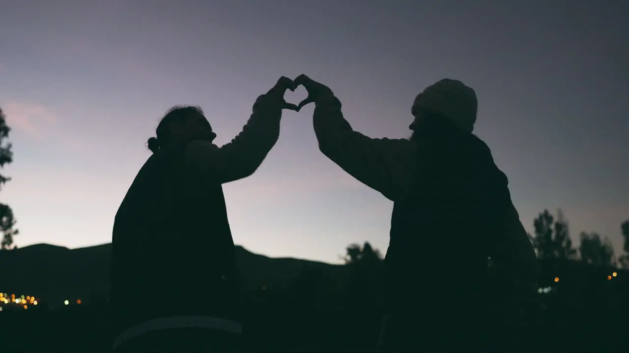 Night sky heart and silhouette of a couple