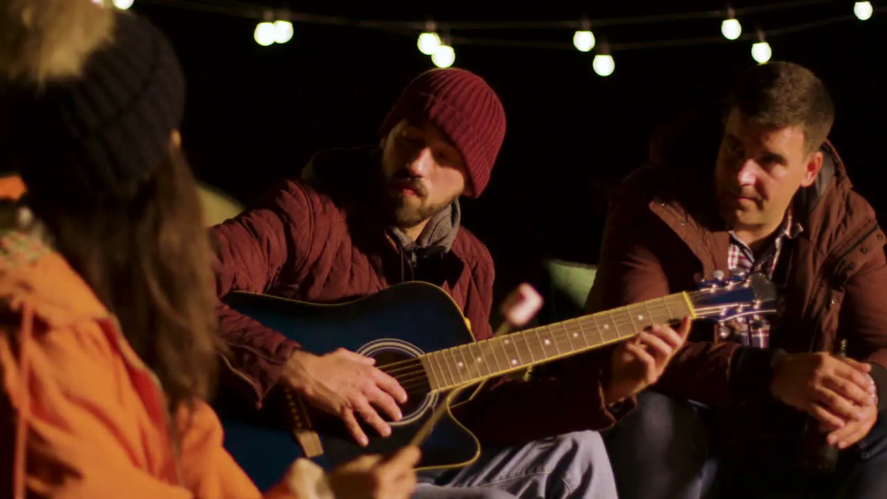 Friends engjoying a guitar solo from one their friends