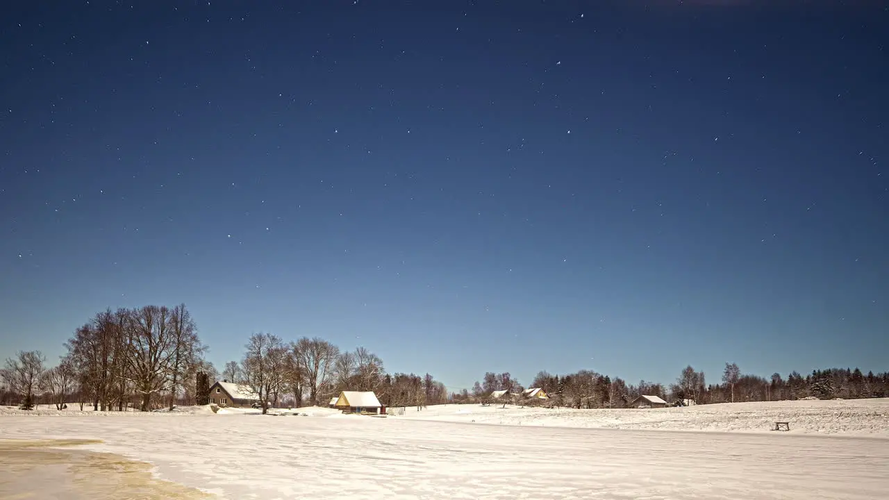 Cirrus clouds disappear while starts are moving above a winter landscape