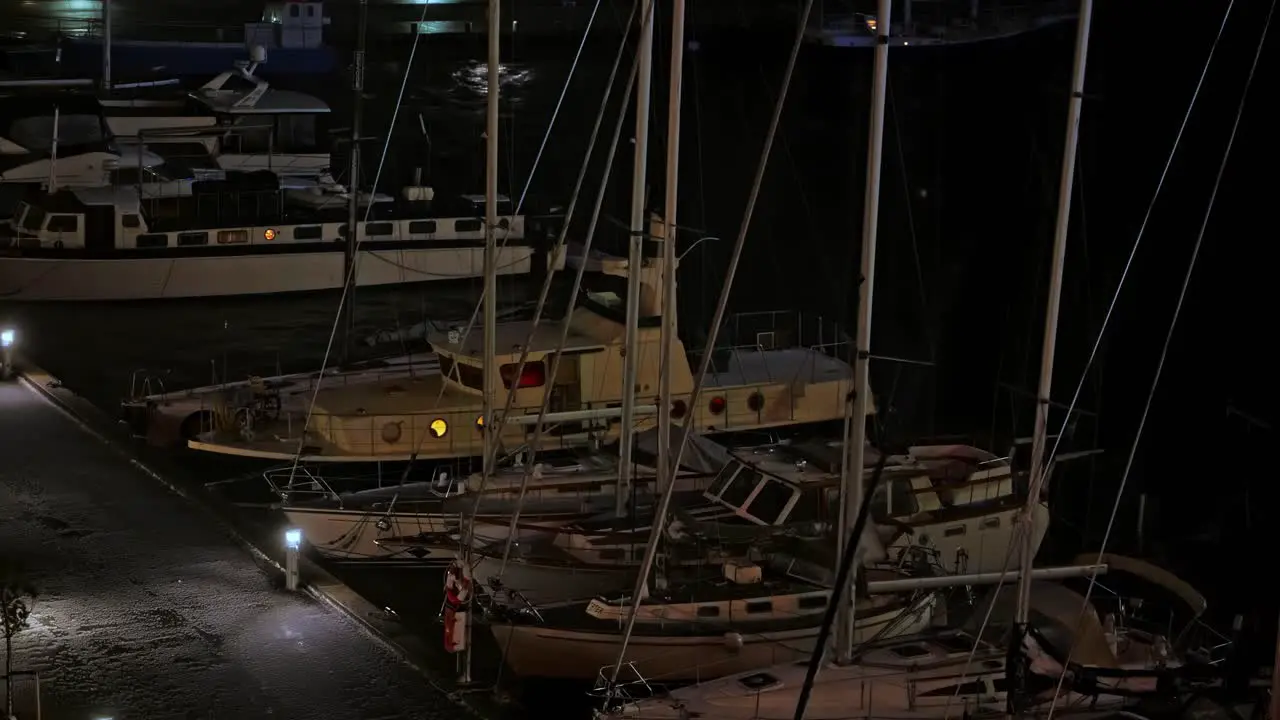 Pleasure boats and yachts are moored at the quays and sway during the night in the strong wind