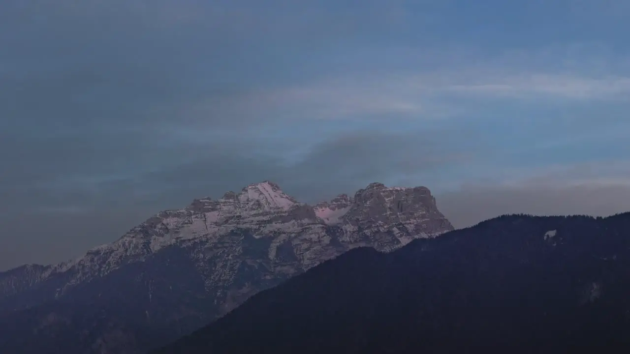 Day to night timelapse of Alps mountain range and snowy rock in Europe