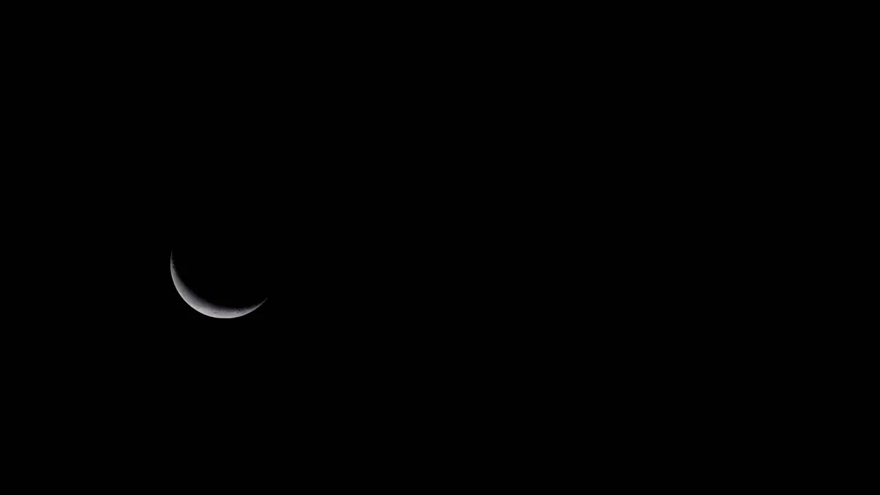 Telephoto Shot of Moon crescent rising at night timelapse