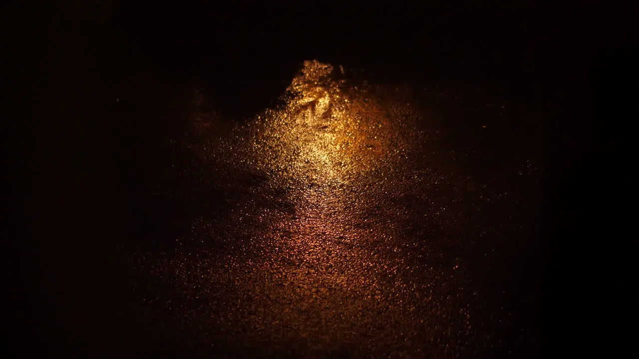 reflecting lit up pavement ground in the dark