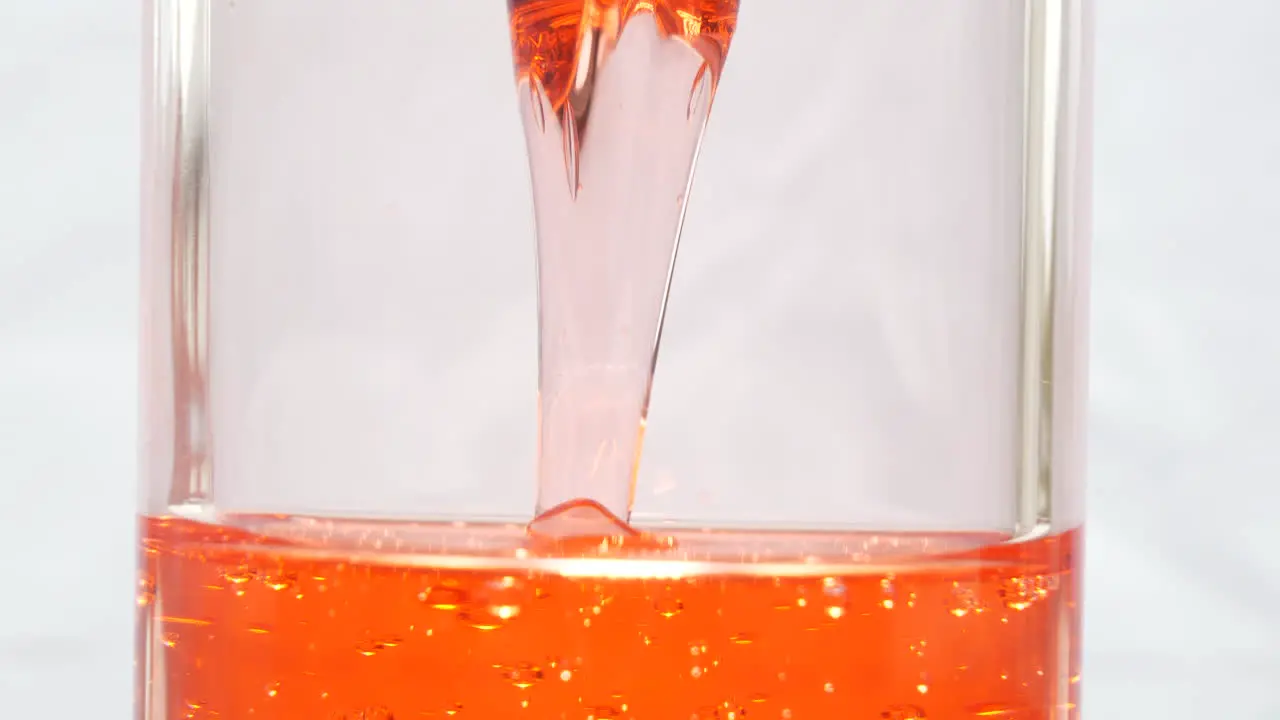 Close up of viscous red liquid in hourglass