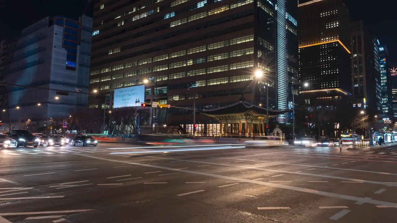 Night Seoul City Night Traffic Rush Hyperlapse at Gwanghwamun Station Crossroads panning from left to right motion