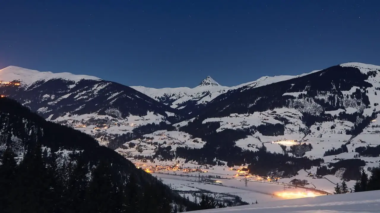 Time lapse of mountain panorama of a snowy ski resort at night