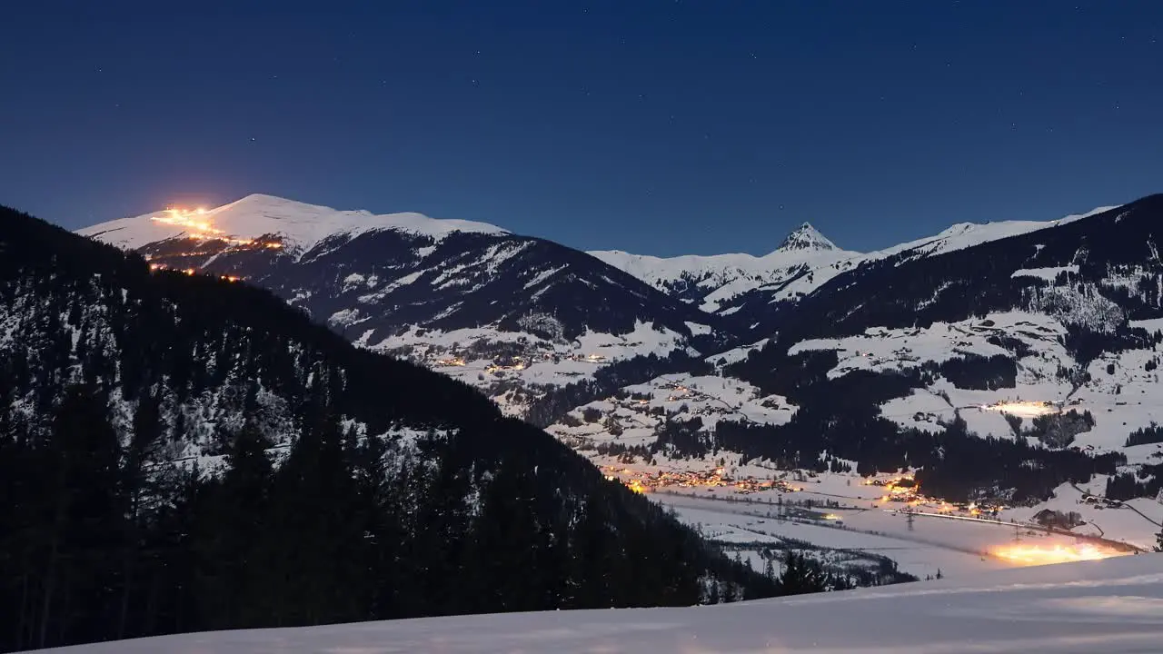 Time lapse of scenic snowy panorama of a ski resort in winter at night