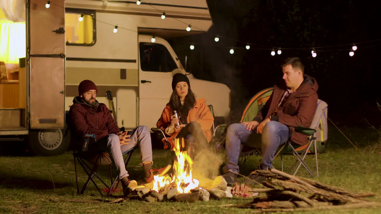 Group of friends enjoying a quiet moment in front of the fire