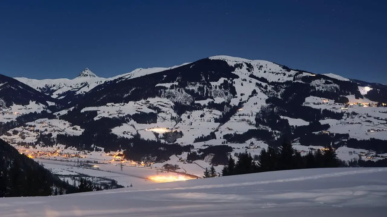 Time lapse of a snowy ski resort at night