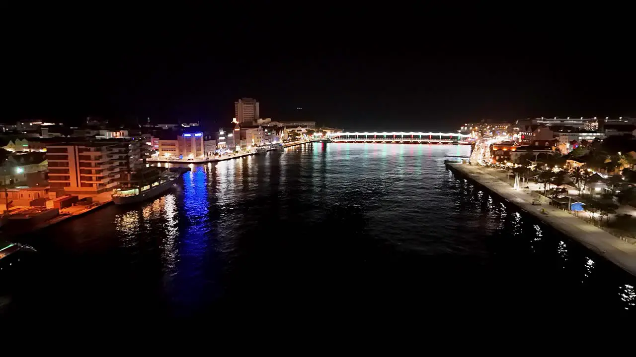 Aerial establish of Willemstad Curacao at night shining from bright lights