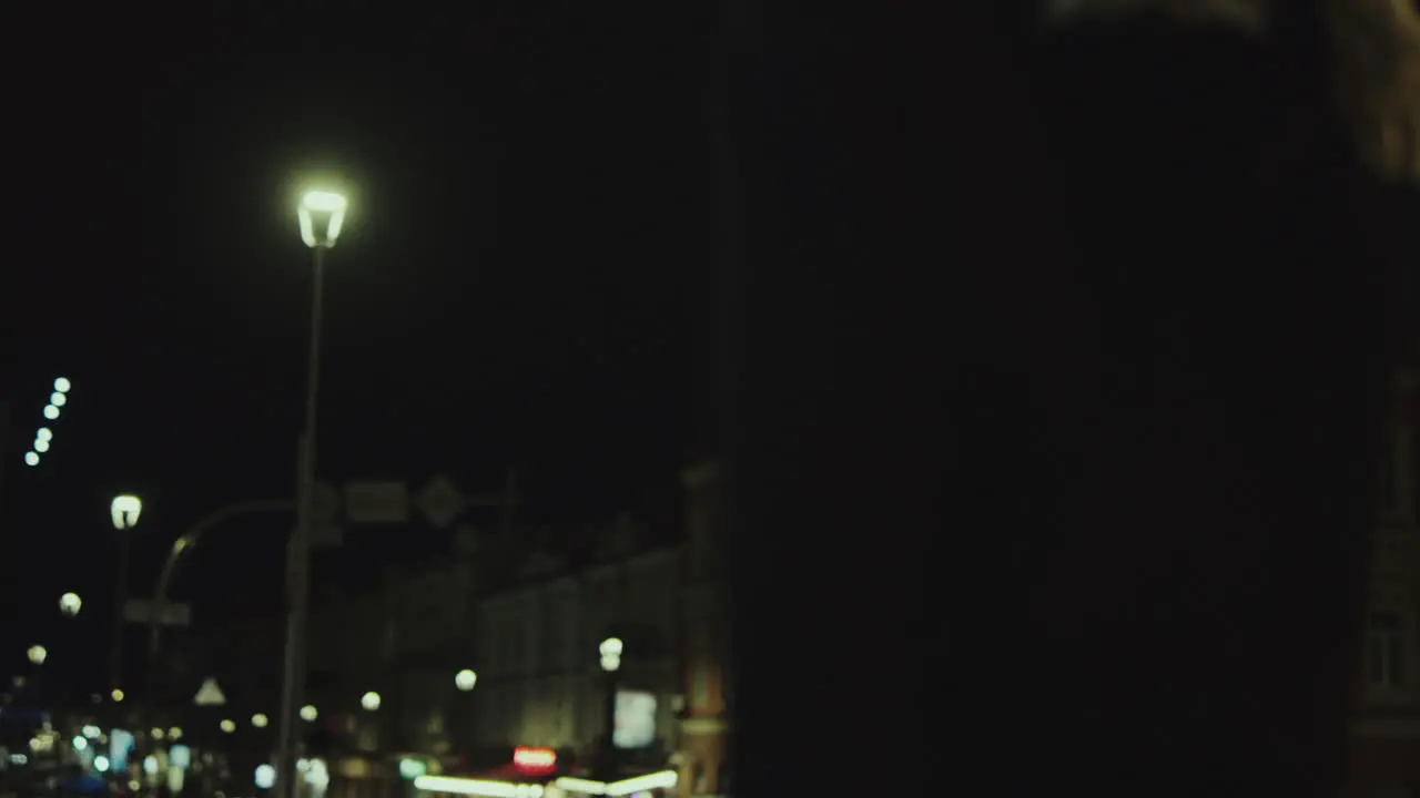 Relaxed woman taking walk at late night in city centre street