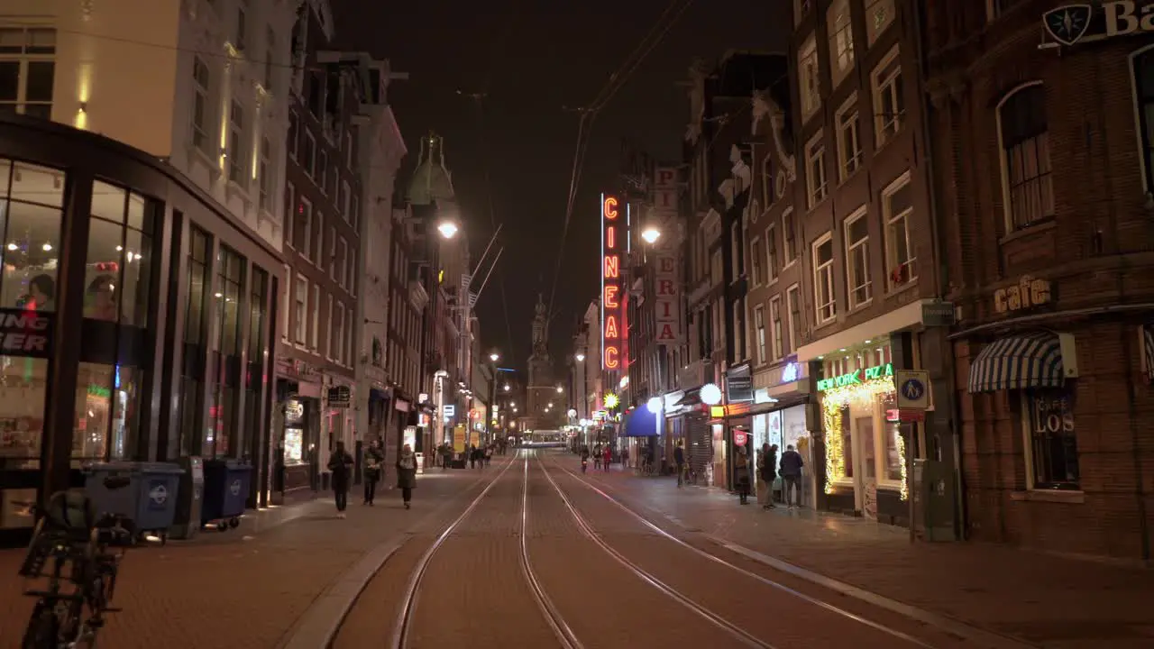 Reguliersbreestraat at night time with people walking around