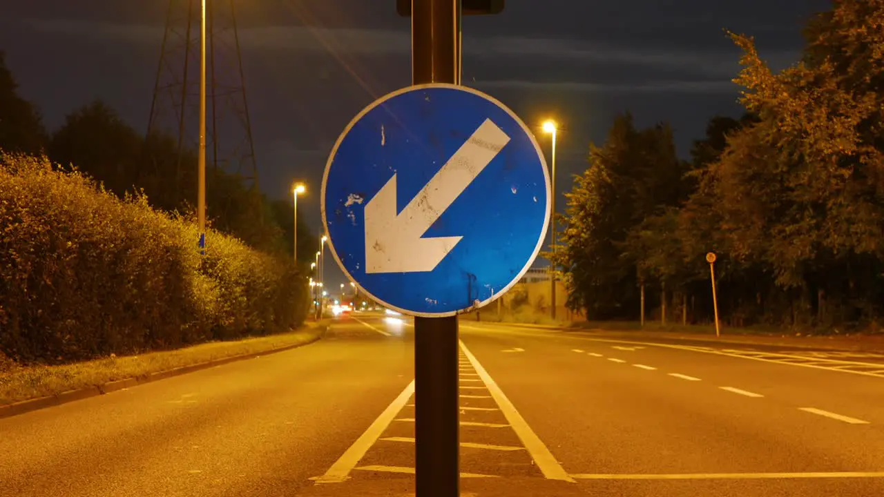 Close Up View Of A Traffic Sign With Motion Timelapse Of Vehicles On The Street In Dublin Ireland At Night