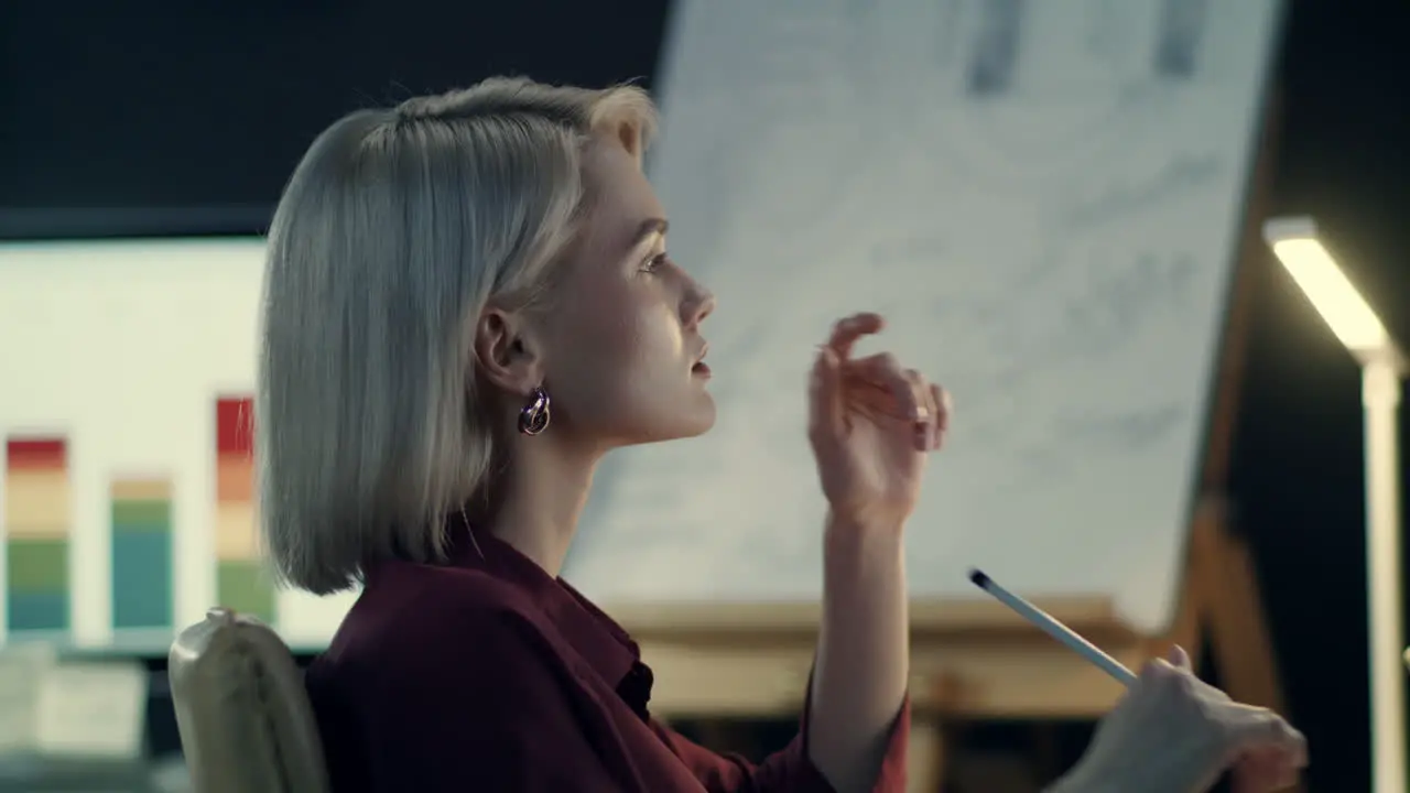 Thoughtful business woman analyzing charts on computer in night office