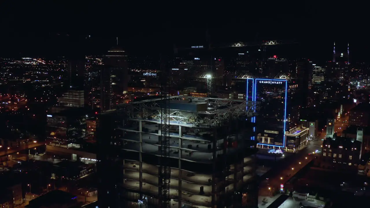 Night aerial of building tower under construction with cranes on top Drone 4K