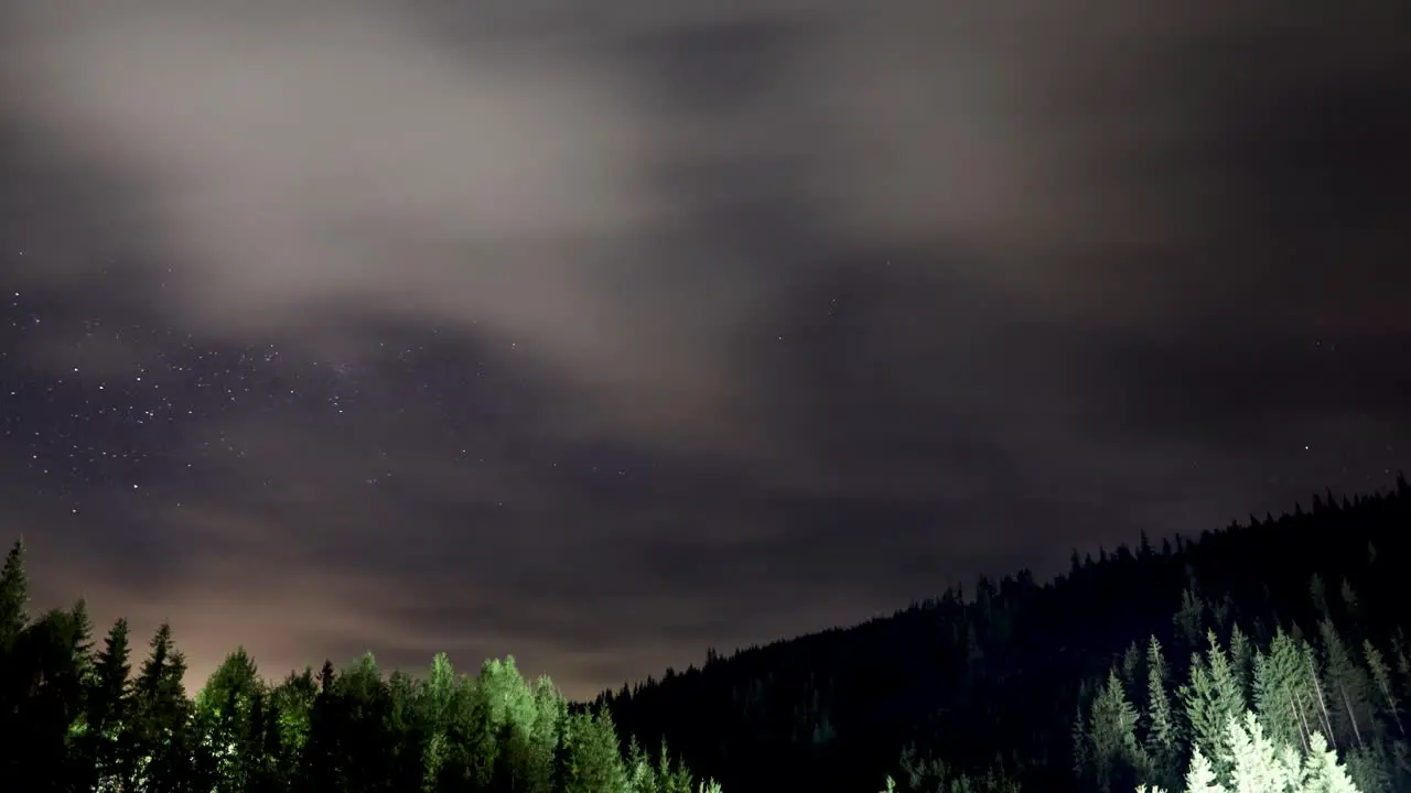 Clouds Moving From The Starry Night Sky Under The Mountain