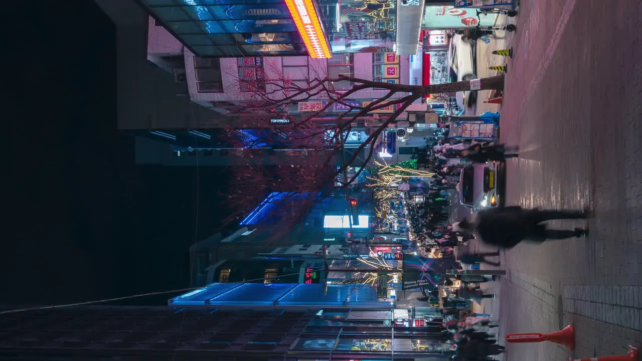 Busy Crowded Street of Myeongdong Night Market with Tourists Traveling Vertical Dynamic Pan Time Lapse