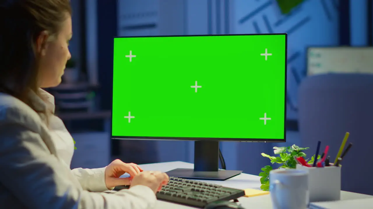 Freelancer working in front of green screen display