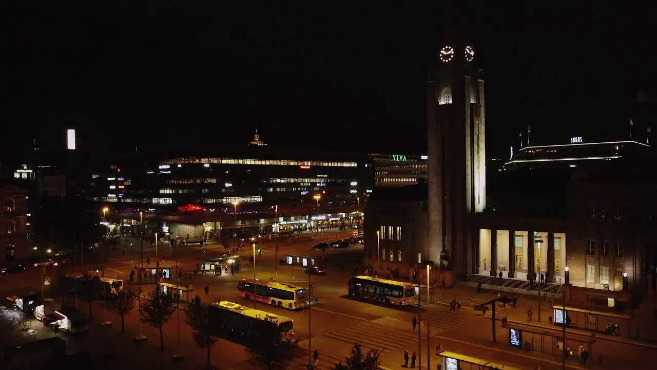 Night aerial rises in Railway Square in downtown Helsinki city life