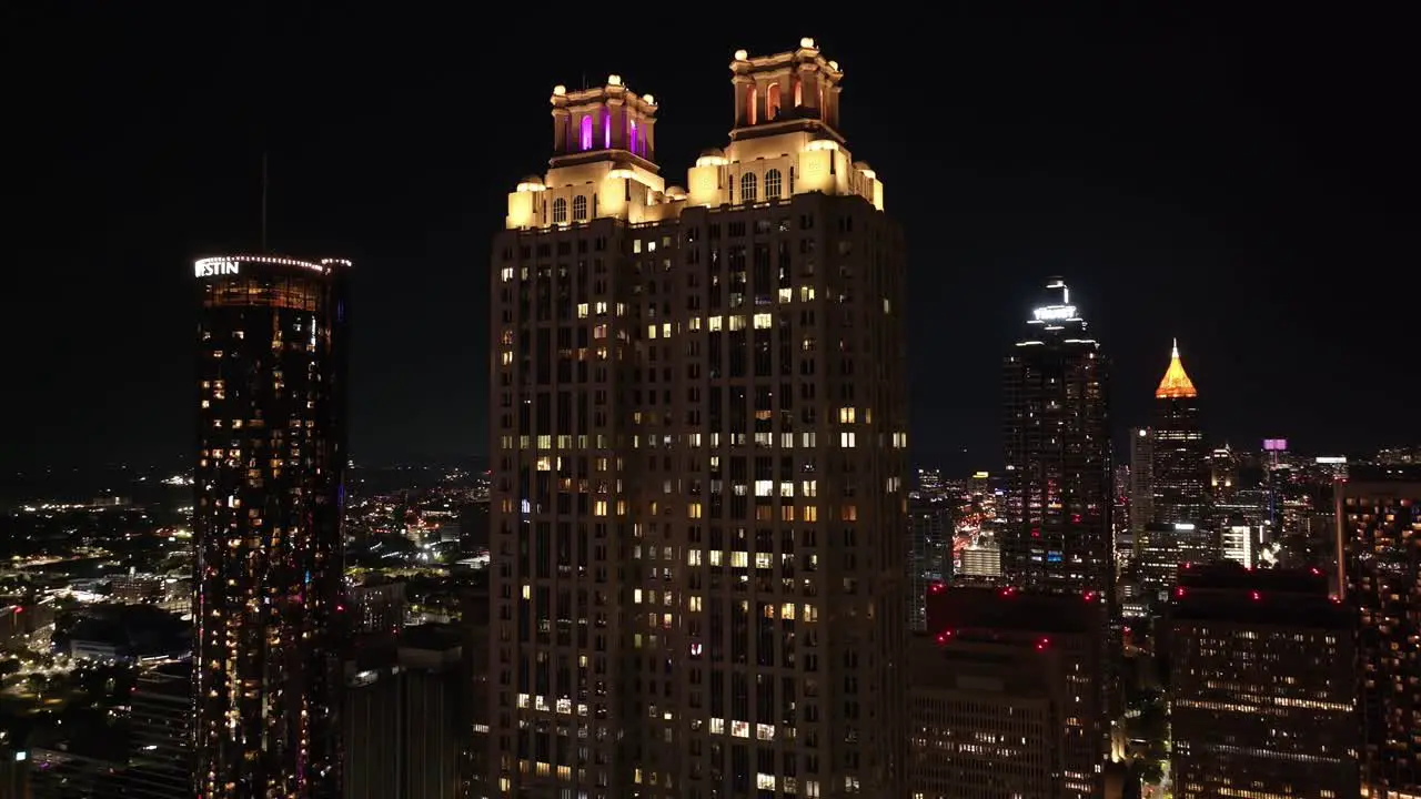 Epic drone view of Atlanta Georgia famous skyscrapers illuminated at night