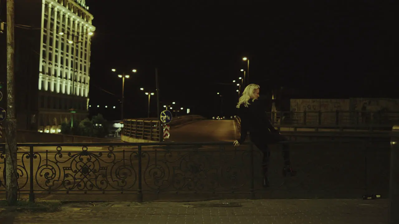 Girl enjoying city view cars passing at late night street in urban area