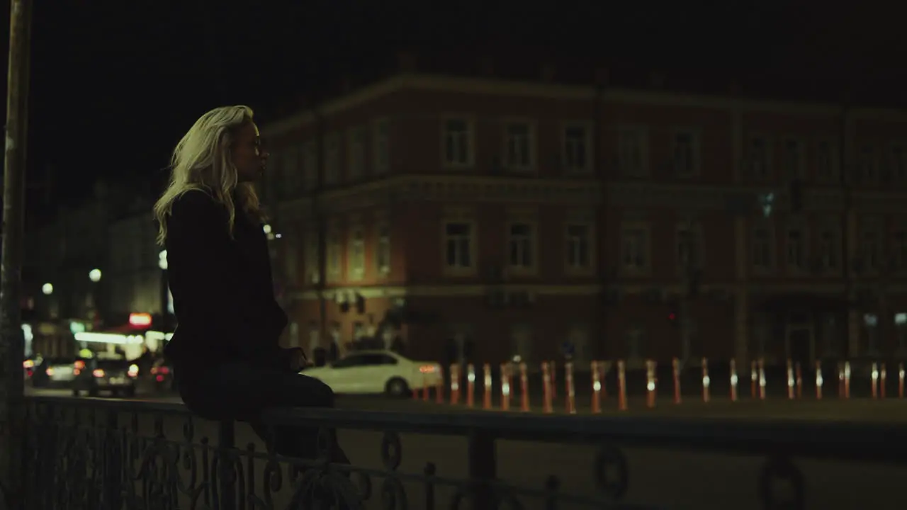 Girl sitting bench night in city lights enjoying city life in downtown