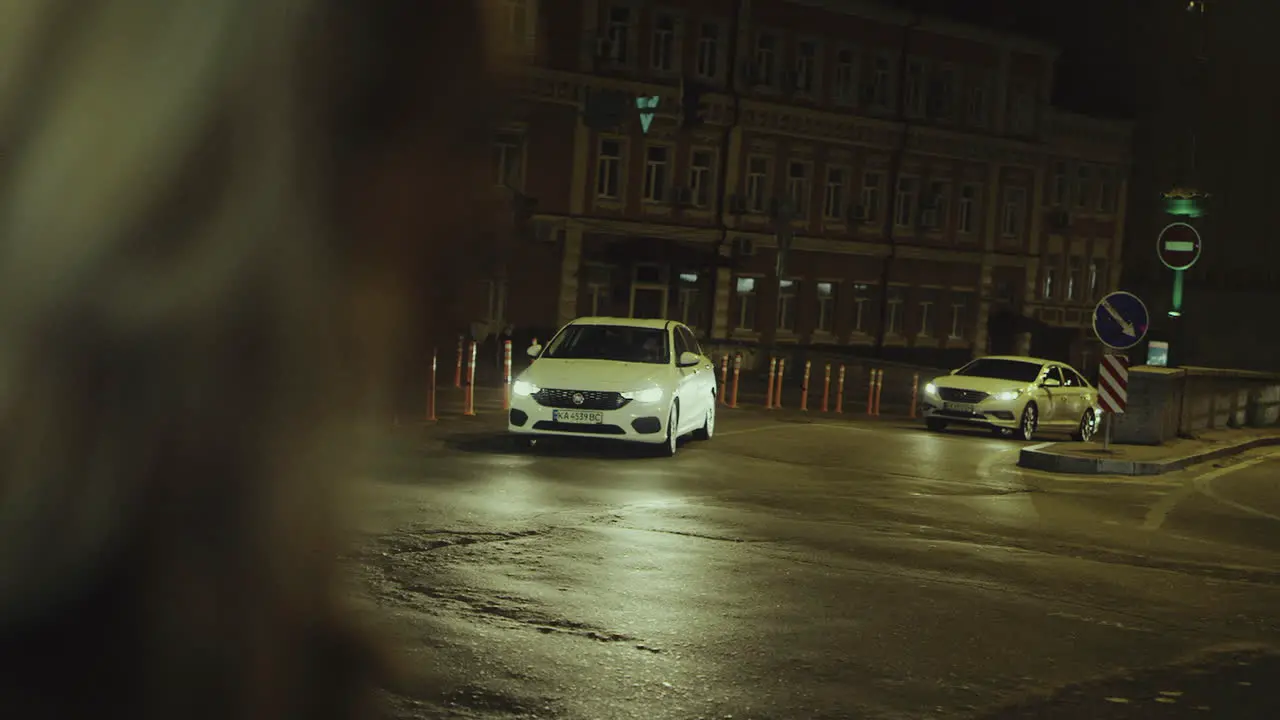 Female face looking city with cars driving street at late night