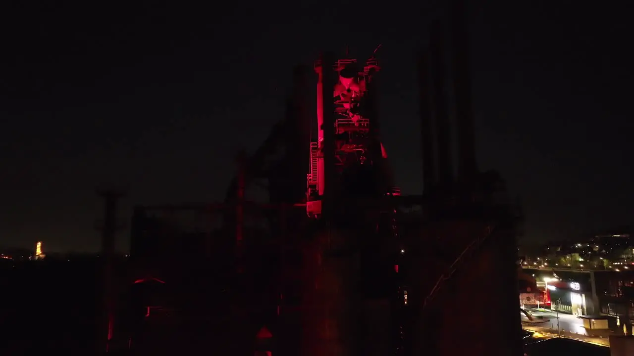 An aerial view of the Bethlehem Steel stacks lit in red at night