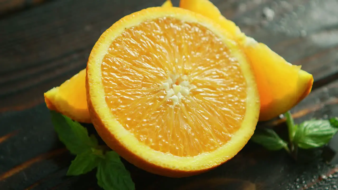 Sliced orange with green leaves 