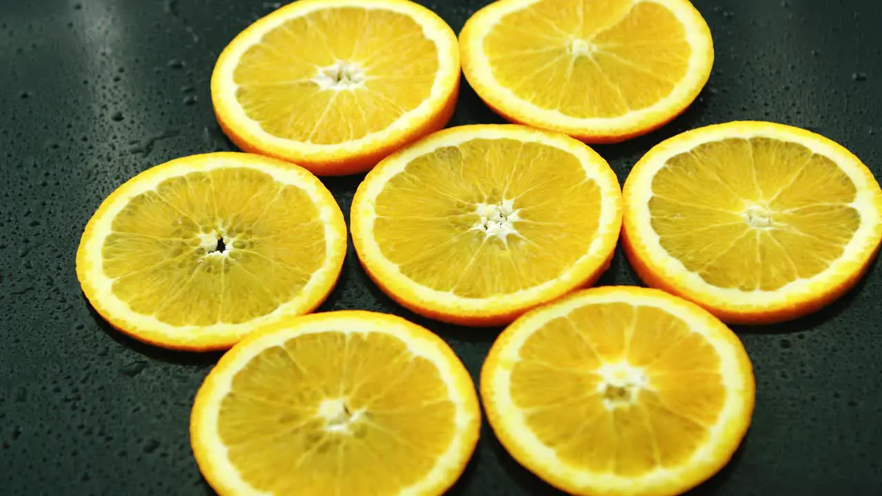 Orange slices on dark desk 