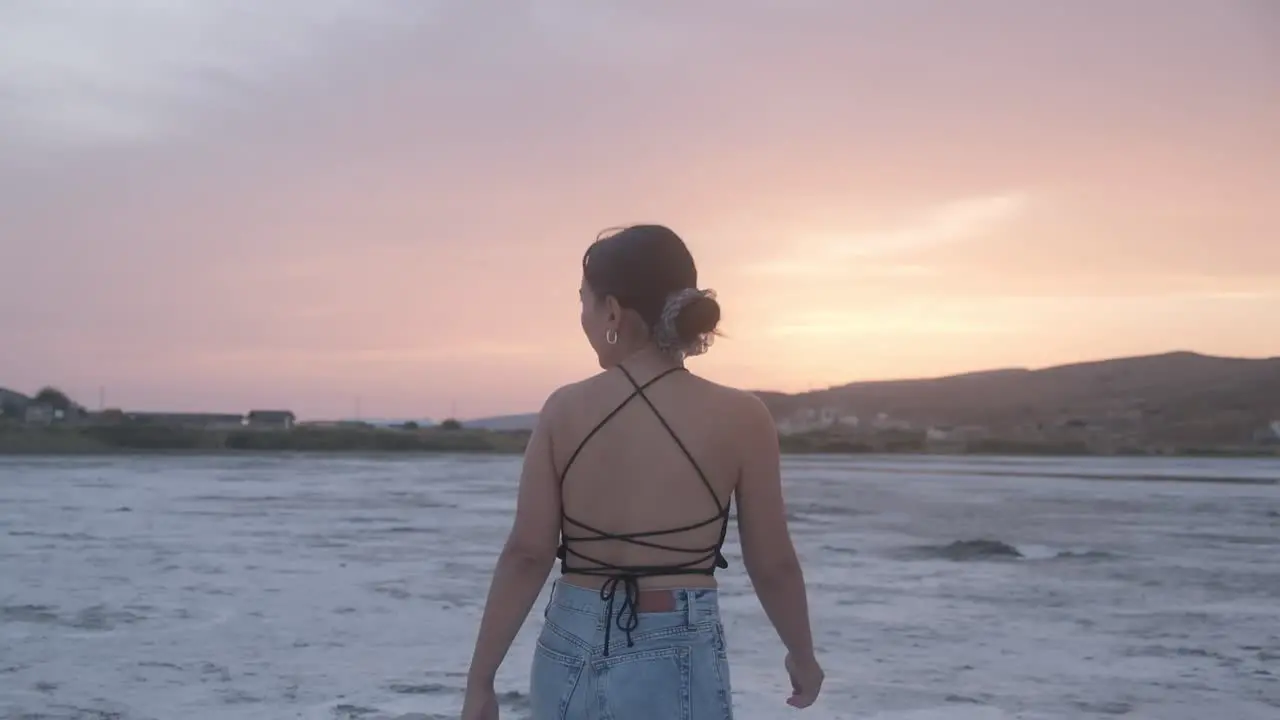 Girl walking on top of Salt Lake in Sunset Time